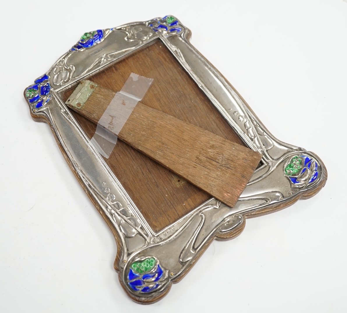 An Edwardian Art Nouveau silver and enamel mounted photograph frame, James Deakin & Sons Ltd, Birmingham, 1902, enamel a.f., 22cm. Condition - poor